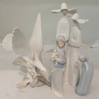 Lot 188 - Four Lladro figures - pair of nuns, kneeling girl and girl with lilies and a dove (4)