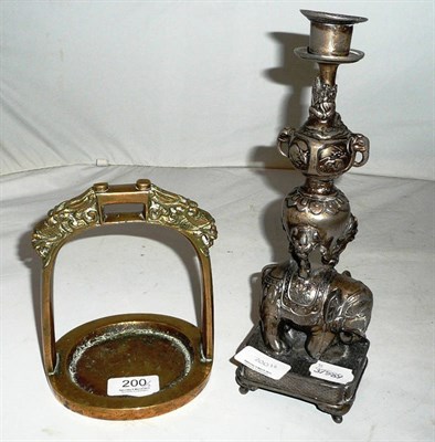 Lot 200 - An Oriental white metal candlestick with elephant base, and a finely cast bronze stirrup, Qing...