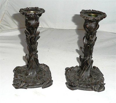 Lot 209 - A pair of French bronze table candlesticks naturalistically cast as sea shells and bulrushes