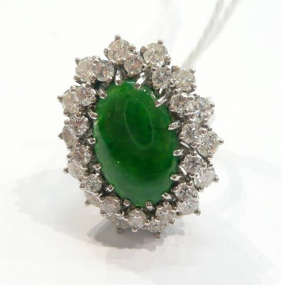 Lot 241 - A jade and diamond cluster ring, an oval cabochon jade within a double border of round...