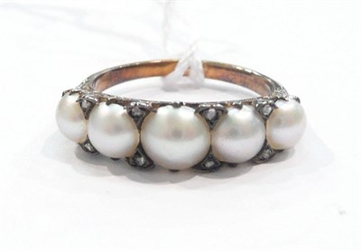 Lot 251 - A split pearl five stone ring with diamond accents