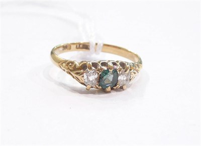 Lot 280 - An emerald and diamond three stone ring