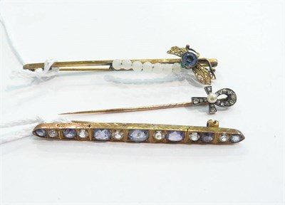 Lot 286 - A pearl and diamond-set 'Ank' cross pin, a sapphire-set brooch and another pin