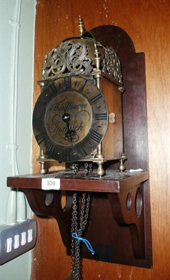 Lot 309 - A modern lantern clock and wall bracket with weight and pendulum