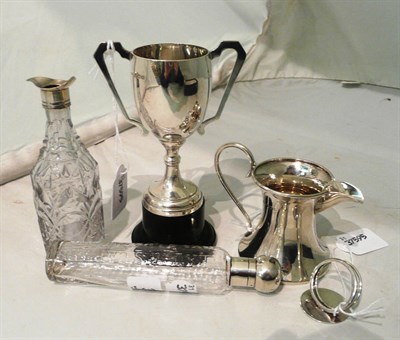 Lot 364 - Silver trophy cup, silver menu holder, silver jug, silver mounted bottle and a French white...