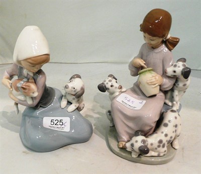 Lot 525 - Two Lladro ceramic figural groups of young girls with puppies