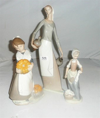 Lot 529 - Three Nao figures - a water carrier, girl carrying pumpkins and a washer girl