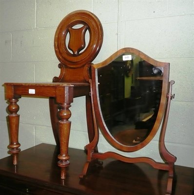 Lot 645 - Victorian oak hall chair and a mahogany shield shape wall mirror