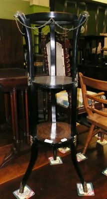 Lot 658 - An ebonised and inlaid three tiered stand with gilt metal mounts