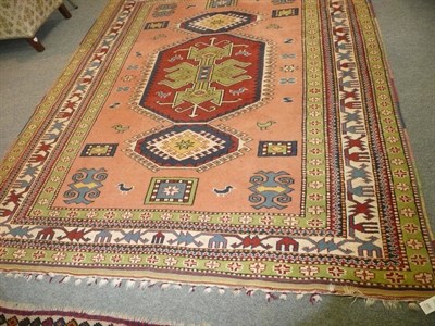 Lot 690 - Green and red ground rug depicting birds