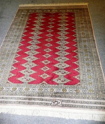 Lot 710 - A Lahore Bukhara rug, the blood red field with rows of linked guls