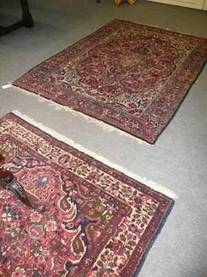 Lot 727 - Two similar red ground rugs