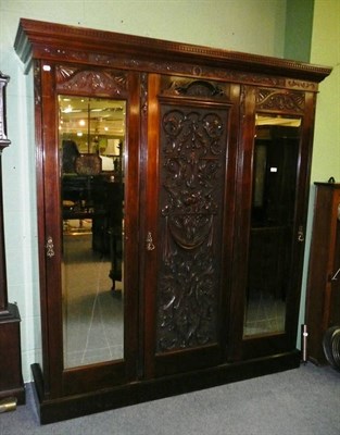 Lot 778 - Late Victorian carved mahogany triple wardrobe and dressing table