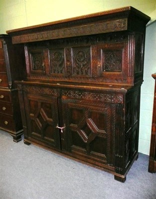 Lot 783 - Carved oak press cupboard