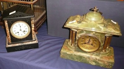 Lot 794 - A black slate mantel clock and an onyx mantel clock