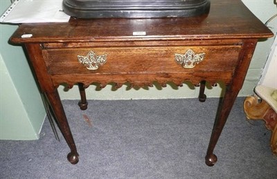 Lot 799 - Oak single drawer lowboy with waved apron