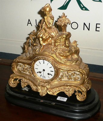 Lot 810 - A gilt metal striking mantel clock on an ebonised base