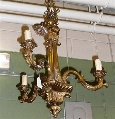 Lot 812 - A pair of brass three light chandeliers (2)