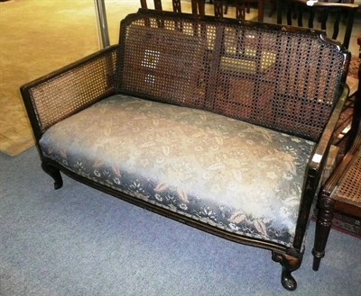 Lot 827 - Ebonised bergere sofa (no cushions)