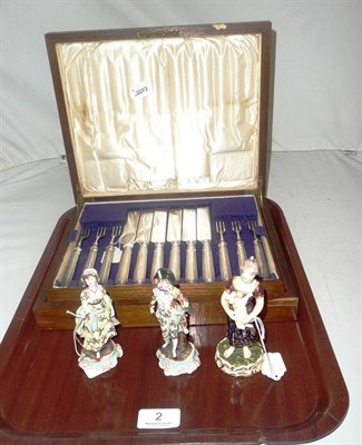 Lot 2 - Derby figure, two Continental figures and set of twelve dessert knives and forks (cased)