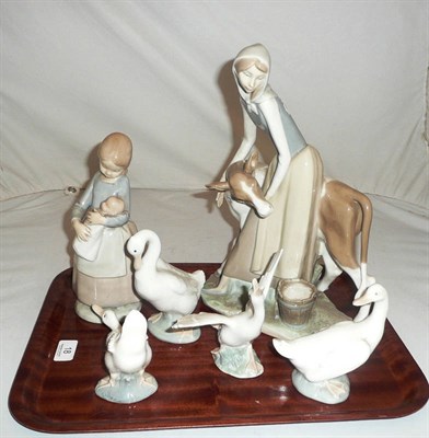 Lot 18 - Lladro group of a girl and a cow, a Nao child and doll, a Lladro duck and three Nao ducks