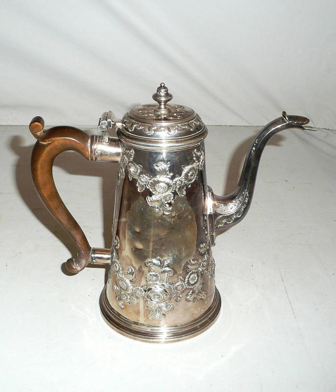 Lot 43 - An early Georgian coffee pot with later Victorian repouse decoration, 22oz