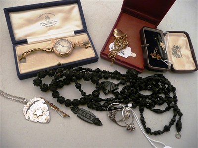 Lot 86 - Jet brooch, French jet beads, a 9ct gold cased lady's wristwatch, a silver shield, assorted...