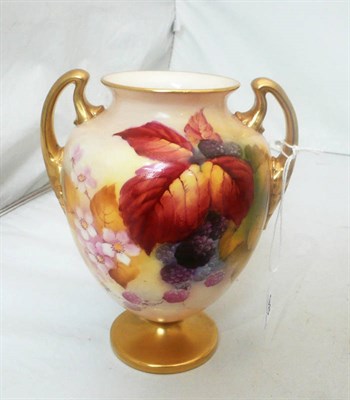 Lot 98 - A Royal Worcester blush ivory twin handled vase painted with fruits and leaves by Kitty Blake