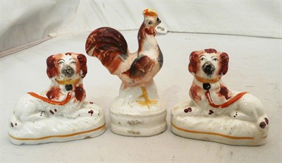 Lot 119 - Staffordshire small cockerel and pair of recumberant spaniels