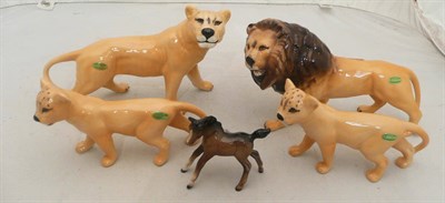 Lot 147 - Four Beswick lions and a foal