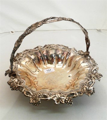 Lot 157 - A large Georgian silver fruit bowl with cast grape vine border and swing handle, 29oz