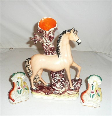 Lot 158 - A Staffordshire 'horse' spill vase and pair of fox and stork groups (3)