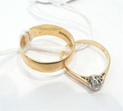 Lot 290 - A 22ct gold band ring and a diamond solitaire ring