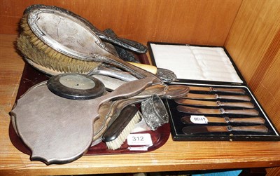 Lot 312 - A tray of silver backed dressing table items and cased set of silver handled tea knives