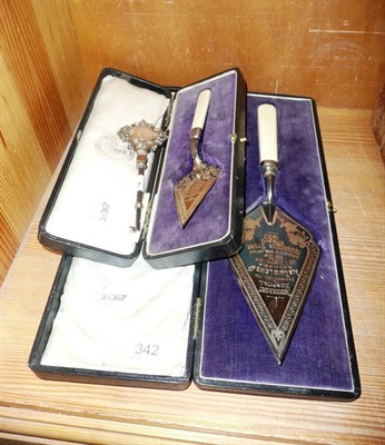 Lot 342 - Silver presentation trowel (cased), a plated presentation towel (cased) and a silver...