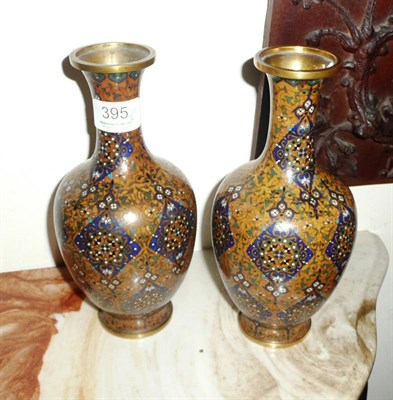 Lot 395 - A pair of cloisonne vases with scrolling foliate decoration