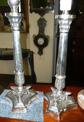 Lot 399 - Pair of silver plated lamp bases on triform base