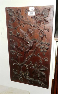 Lot 460 - A carved panel 'monogrammed, MJ' depicting a bird with foliage, flowers and blackberries