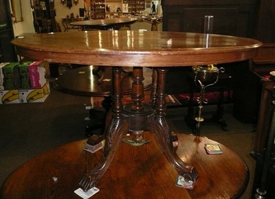 Lot 494 - An oval table and a three tier cake stand