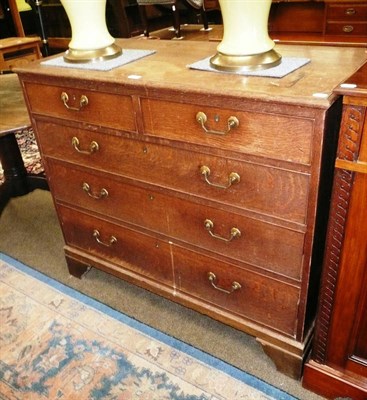 Lot 515 - An oak four height chest on bracket feet