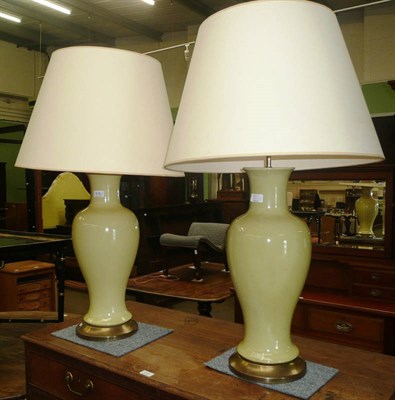 Lot 516 - A pair of large yellow ceramic table lamps with shades