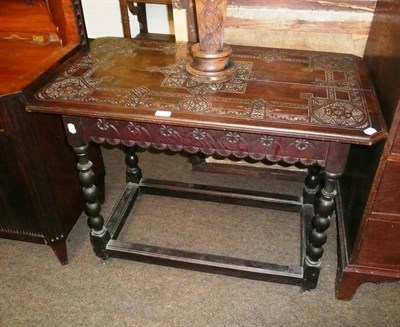 Lot 526 - Oak table with a carved top