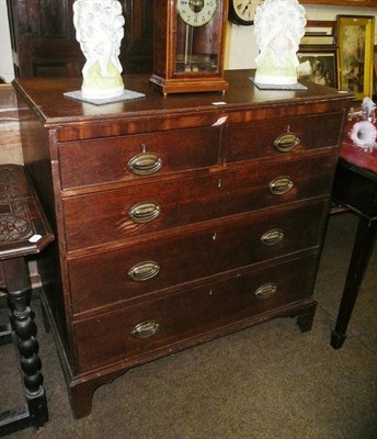 Lot 527 - An oak four height chest on bracket feet