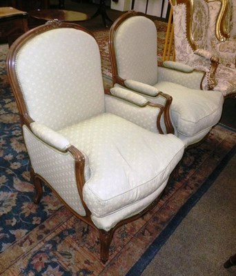 Lot 531 - Pair of reproduction large carved beech armchairs in Louis XV style, pale green upholstery,...