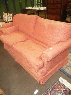 Lot 556 - Orange sofa and matching armchair with squabs