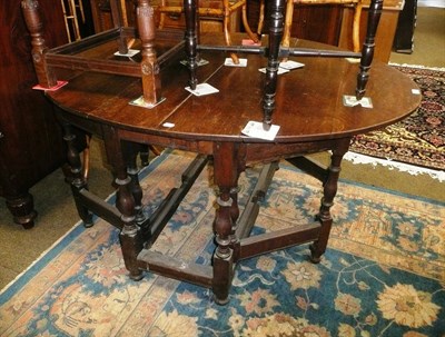 Lot 568 - Am oak gateleg table with single drawer