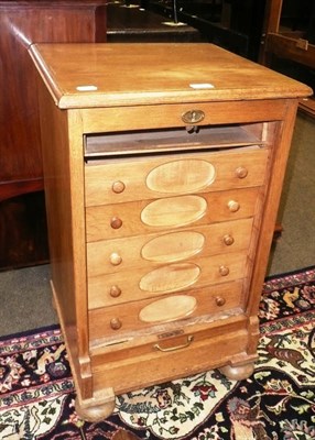 Lot 579 - An oak five drawer chest with tambour front