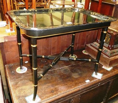 Lot 581 - Black and gilt coffee table with lift off 19th century papier mache tray top, with glass protector