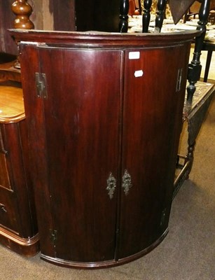 Lot 587 - Mahogany bow fronted hanging corner cupboard