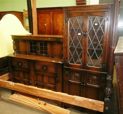 Lot 593 - A reproduction oak glazed floor standing corner cabinet and an oak sideboard